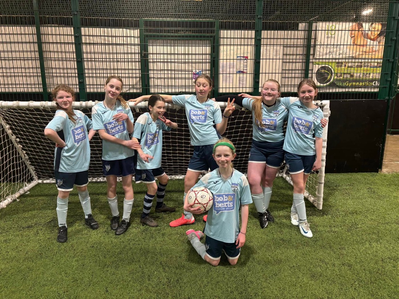 Carnalridge Primary School pupils celebrating with their football team